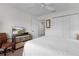 Bedroom features large closet, neutral carpet, and views of the front yard on the television at 627 Leeds Pl, The Villages, FL 32162