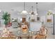 Open breakfast nook with a glass-top table and views of living areas for seamless entertaining and casual dining at 627 Leeds Pl, The Villages, FL 32162
