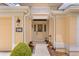 Inviting front entrance with a decorative door, attractive potted plants, and a convenient bench creating a warm welcome at 627 Leeds Pl, The Villages, FL 32162