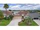 Charming single-story home with a two-car garage, well-manicured lawn, and attractive landscaping at 627 Leeds Pl, The Villages, FL 32162