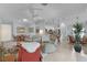 Bright open-concept living space featuring tile floors, modern furnishings, and an adjacent dining area and kitchen at 627 Leeds Pl, The Villages, FL 32162