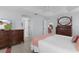 Bright main bedroom features a ceiling fan, en suite bath and dark wood furniture set at 627 Leeds Pl, The Villages, FL 32162