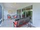 Comfortable seating arrangement on the screened porch, perfect for enjoying the serene outdoor views at 627 Leeds Pl, The Villages, FL 32162