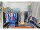 Walk-in closet equipped with extensive shelving, hanging rods, and efficient storage solutions at 627 Leeds Pl, The Villages, FL 32162