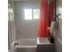 Bathroom featuring a tub with coral curtain, a sink, and a mirror at 640 Mansfield Rd, Tavares, FL 32778
