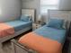 Bedroom with two beds, side table, and window for a comfortable and inviting space at 640 Mansfield Rd, Tavares, FL 32778