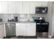 Updated kitchen with stainless steel appliances and ample counter space at 640 Mansfield Rd, Tavares, FL 32778