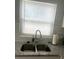 Kitchen featuring updated faucet, granite counters and bright, sunny window at 640 Mansfield Rd, Tavares, FL 32778
