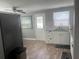 Well-lit kitchen boasts modern fixtures, stainless sink and appliances, and ample counter space at 640 Mansfield Rd, Tavares, FL 32778