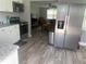 Modern kitchen features stainless steel appliances and white cabinetry at 640 Mansfield Rd, Tavares, FL 32778