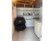 A convenient laundry room featuring shelving, and a modern washer and dryer for efficient chores at 640 Mansfield Rd, Tavares, FL 32778