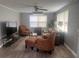 A comfortable living room with furniture and ceiling fan at 640 Mansfield Rd, Tavares, FL 32778