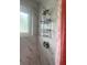 Bathroom shower stall with modern fixture and a window, complimented with a coral curtain at 640 Mansfield Rd, Tavares, FL 32778