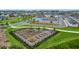 Aerial view of community garden with raised beds and lush landscaping in a residential neighborhood at 6480 Barnstorm Way, St Cloud, FL 34771
