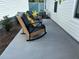 Comfortable outdoor seating area with stylish rocking chairs and a small table on the back patio at 680 Joseph Way, The Villages, FL 34762