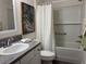 Bathroom boasts a clean design with tub and shower combination, white subway tile, and neutral decor at 680 Joseph Way, The Villages, FL 34762