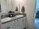 Double vanity bathroom with white cabinets and modern fixtures at 680 Joseph Way, The Villages, FL 34762