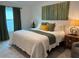 Bedroom featuring a large window, artwork, and cozy decor at 680 Joseph Way, The Villages, FL 34762