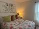 Bedroom featuring queen bed with floral patterned coverlet at 680 Joseph Way, The Villages, FL 34762