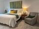 Comfortable bedroom with chair, lamp, and art at 680 Joseph Way, The Villages, FL 34762
