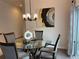 Elegant dining area featuring a modern light fixture, stylish artwork, and seating for four at 680 Joseph Way, The Villages, FL 34762