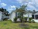 Well-maintained home exterior showcasing manicured lawn and a glimpse of the charming facade at 680 Joseph Way, The Villages, FL 34762
