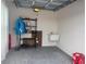 Clean, unfinished garage space featuring a sink, storage shelving, and ample room for parking at 680 Joseph Way, The Villages, FL 34762