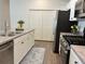 Contemporary kitchen with stainless steel appliances and white cabinets at 680 Joseph Way, The Villages, FL 34762