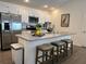 Kitchen featuring a stainless steel fridge, white cabinets, and barstool seating at 680 Joseph Way, The Villages, FL 34762