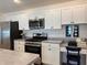 Modern kitchen featuring stainless steel appliances and a workstation at 680 Joseph Way, The Villages, FL 34762