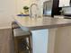 Kitchen island with bar seating, stainless steel sink, and updated countertops at 680 Joseph Way, The Villages, FL 34762