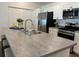 Modern kitchen featuring stainless steel appliances, ample counter space, and white cabinetry at 680 Joseph Way, The Villages, FL 34762