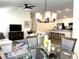 Open-concept layout connecting the living area, dining space, and kitchen, perfect for entertaining at 680 Joseph Way, The Villages, FL 34762