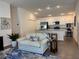 Inviting open-concept living space with a comfortable sofa, kitchen bar, and modern finishes at 680 Joseph Way, The Villages, FL 34762