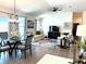 Open-concept living area with a dining table, comfortable seating, and vaulted ceiling at 680 Joseph Way, The Villages, FL 34762