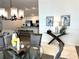 Open concept layout showcasing a dining area and living area with a modern kitchen in the background at 680 Joseph Way, The Villages, FL 34762
