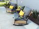 Inviting patio space with comfortable rocking chairs and decorative pillows perfect for relaxing outdoors at 680 Joseph Way, The Villages, FL 34762