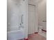 Clean bathroom features a shower-tub with safety bar and a white tiled shower, along with a toilet and closet at 712 Old Oaks Ln, Leesburg, FL 34748