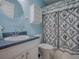 Bathroom featuring a round mirror and shower at 712 Old Oaks Ln, Leesburg, FL 34748