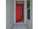 Welcoming foyer with a red front door, tiled floor, and neutral interior walls at 712 Old Oaks Ln, Leesburg, FL 34748