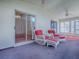 Enclosed lanai with furniture and ceiling fan at 712 Old Oaks Ln, Leesburg, FL 34748