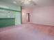 Open-concept living area with pink carpet, featuring access to a kitchen and other rooms at 712 Old Oaks Ln, Leesburg, FL 34748