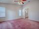 Spacious bedroom with large windows and ensuite bathroom at 712 Old Oaks Ln, Leesburg, FL 34748