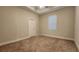 Carpeted bedroom with a ceiling fan, window with blinds and neutral paint at 7955 Delwin Ln, Reunion, FL 34747