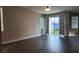 Bedroom with wood floors, large sliding doors, and a neutral paint color at 7955 Delwin Ln, Reunion, FL 34747