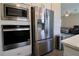 Modern stainless steel appliances including a refrigerator, oven and microwave at 7955 Delwin Ln, Reunion, FL 34747