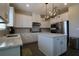 Bright kitchen features white cabinets, stainless steel appliances, and a center island with marble countertops at 7955 Delwin Ln, Reunion, FL 34747