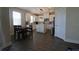 Open kitchen with an island, white cabinets, stainless steel appliances and a dining table at 7955 Delwin Ln, Reunion, FL 34747