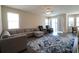 Spacious living room with an area rug, sofas, ceiling fan and natural light at 7955 Delwin Ln, Reunion, FL 34747