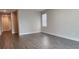 Open concept living room with wood-look flooring and plenty of natural light at 7955 Delwin Ln, Reunion, FL 34747